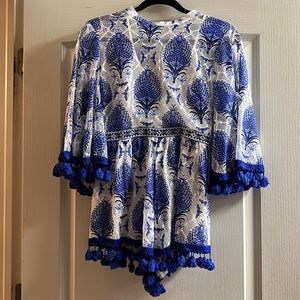 Perfect blue and white vacation romper with pompom trim and peek-a-boo back